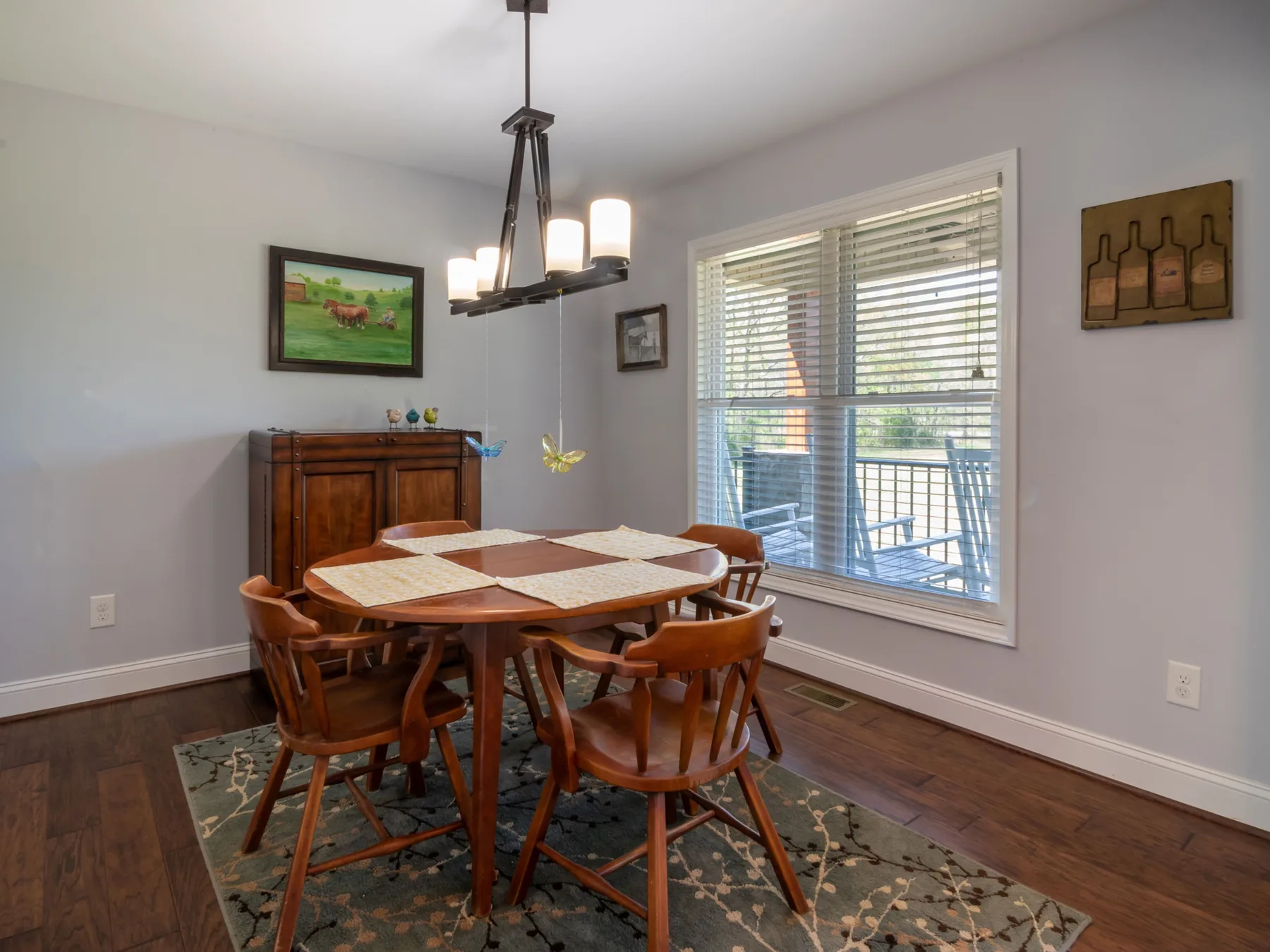 Round dining table and six chairs in a measured residential dining area